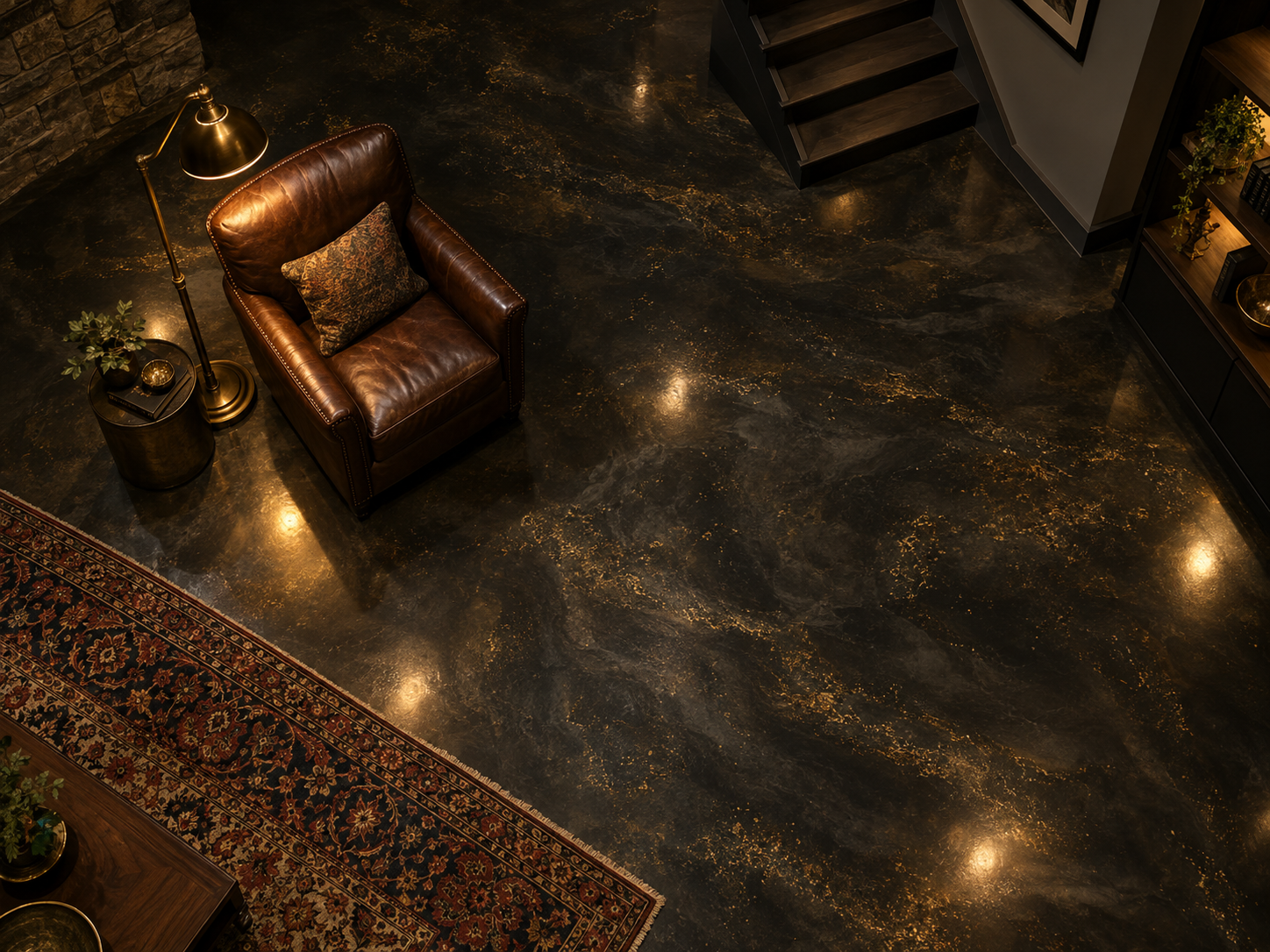 An overhead view of a finished LYON metallic concrete floor in a residential space with a leather chair and a bronze floor lamp.