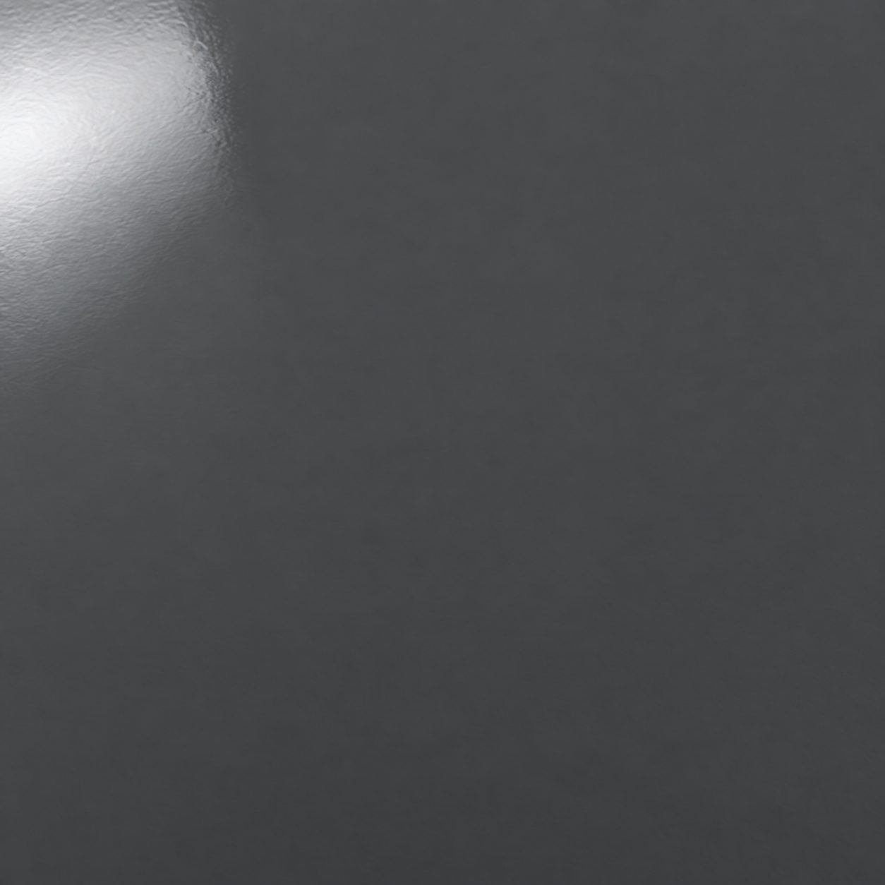 A solid charcoal polyaspartic concrete floor coating sample with a glossy uniform finish.
